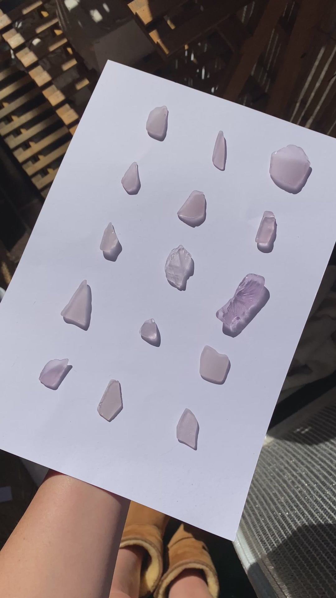 Flatlay of assorted lavender sea glass pieces for custom handmade ring design in Australia